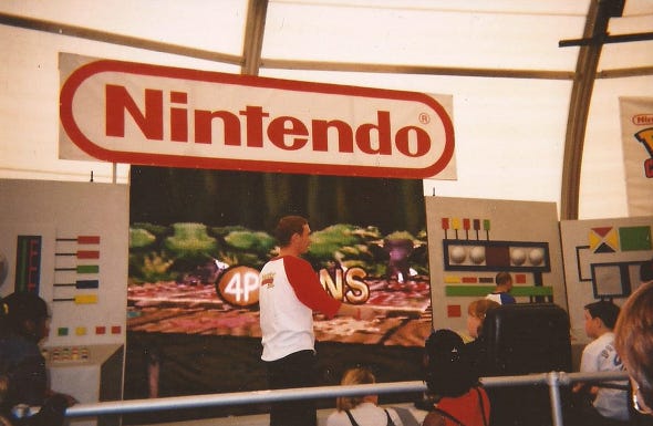 A photograph of the stage with a large screen and a huge Nintendo logo above it