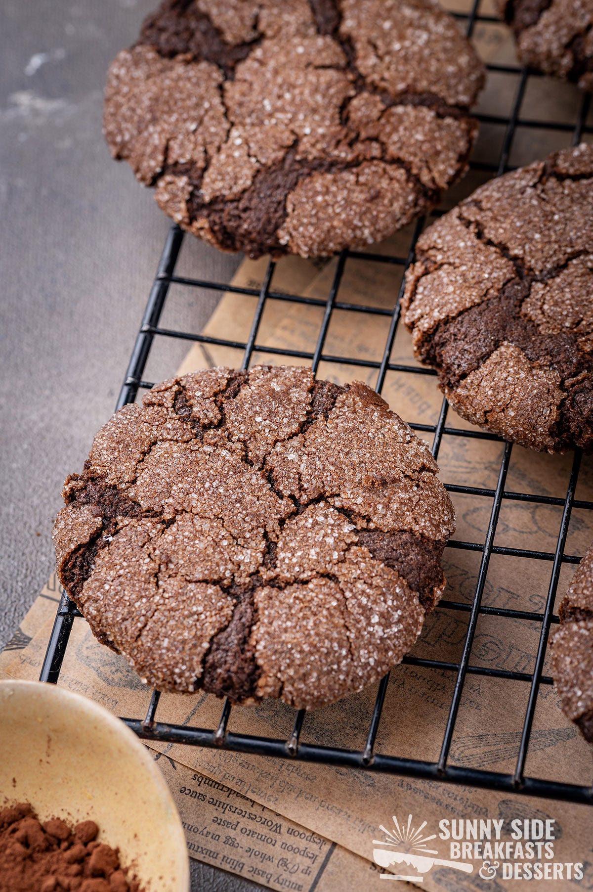 Chocolate earthquake cookies on a cooling wire rack.