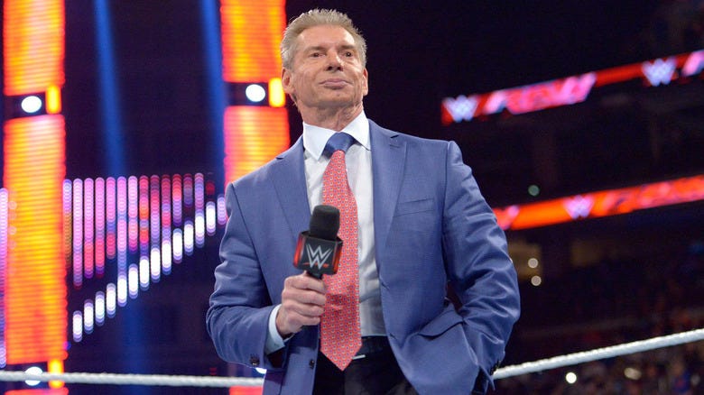 Vince McMahon holding a WWE microphone
