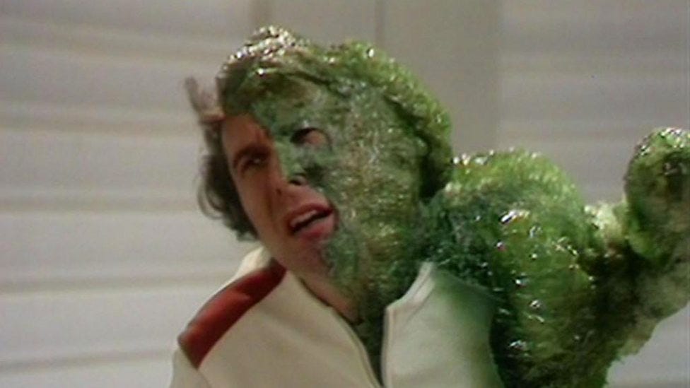 Human half-covered in green bubble wrap as it turns into an alien