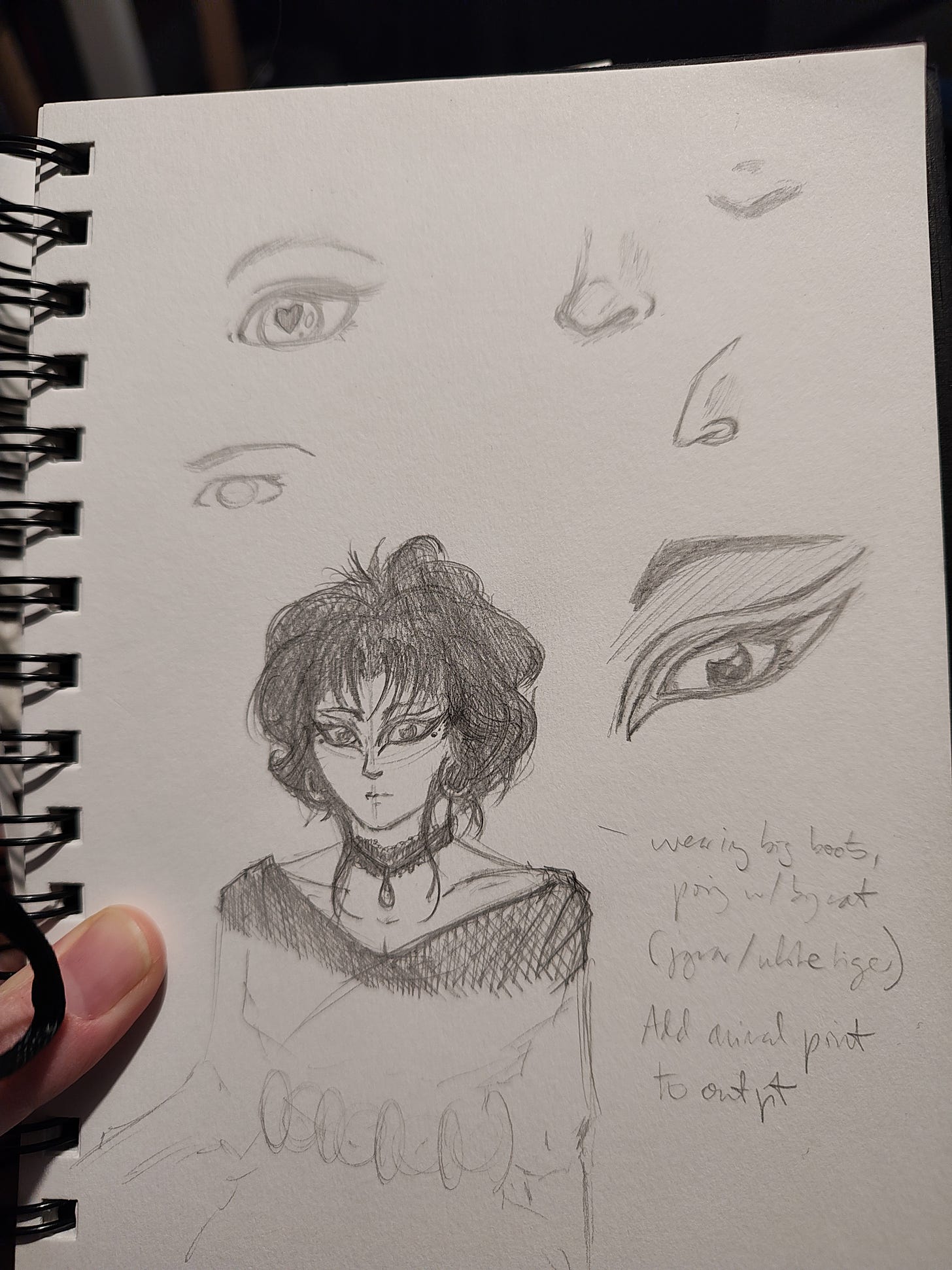 Photo of a sketchbook page showing pencil sketches of eyes, noses, and a lasy in 80s goth style with backcombed hair and heavy eyeliner.