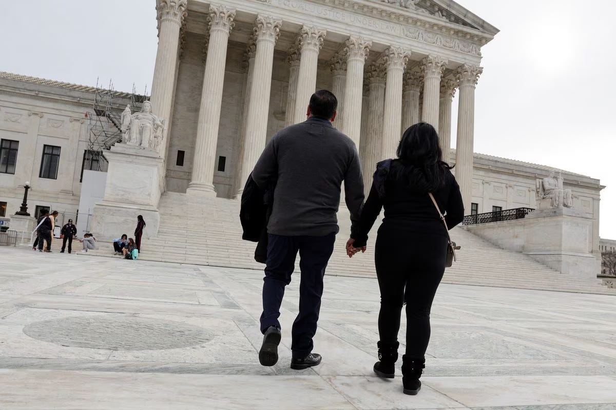 Beatrice Gonzalez and Jose Hernandez, the mother and stepfather of Nohemi Gonzalez, who was fatally shot and killed in a 2015 rampage by Islamist militants in Paris, walk to pose for a picture with a member of their legal team outside the U.S. Supreme Court in Washington, U.S., February 16, 2023, days before justices are scheduled hear arguments in Gonzalez v. Google, challenging federal protections for internet and social media companies freeing them of responsibility for content posted by users in a case involving social media giant Google and its subsidiary YouTube, whom they argue bear some responsibility for their daughter’s death