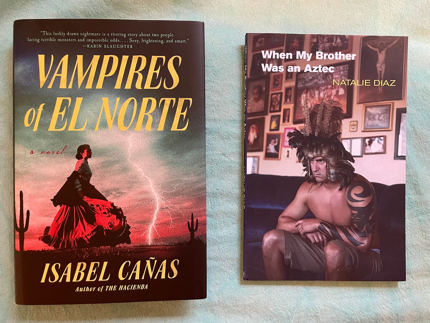 two books: 'Vampires of El Norte' by Isabel Cañas and 'When My Brother Was An Aztec' by Natalie Diaz
