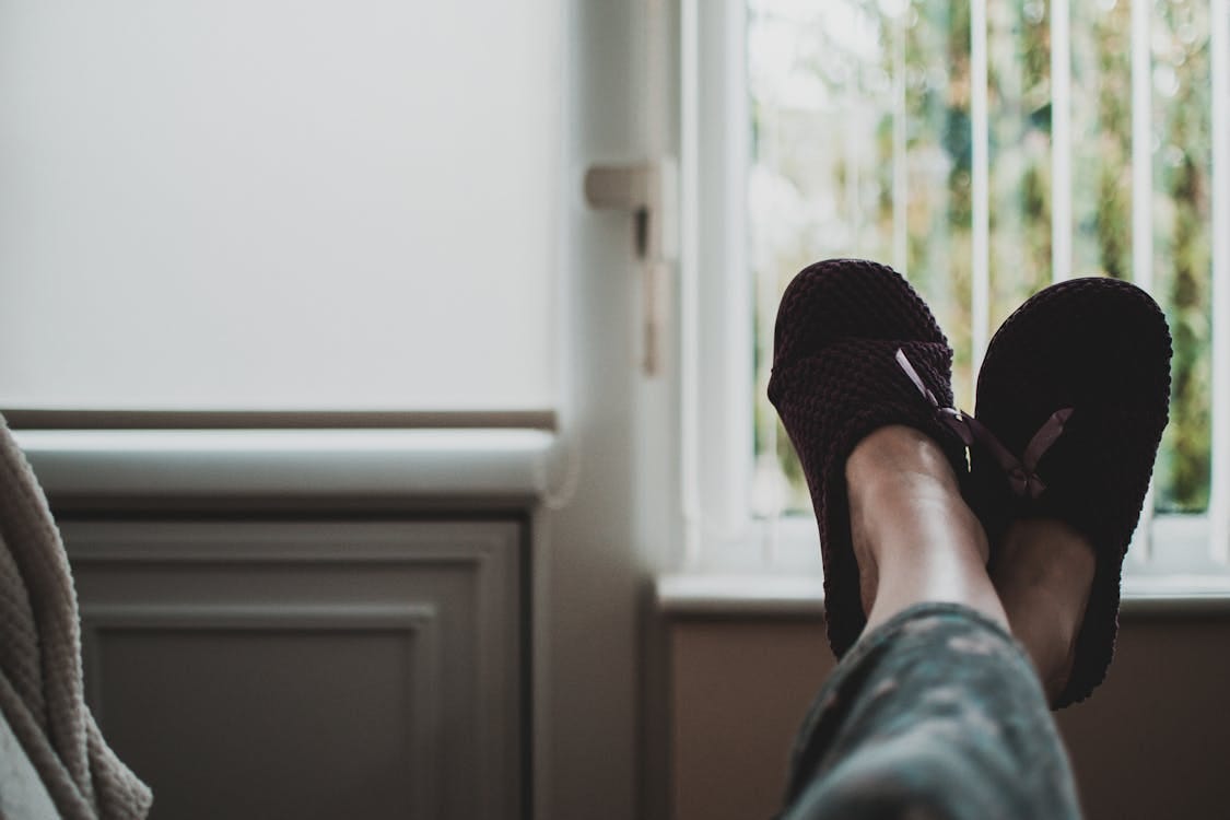 Free Person Wearing Pair of Black Slides Stock Photo