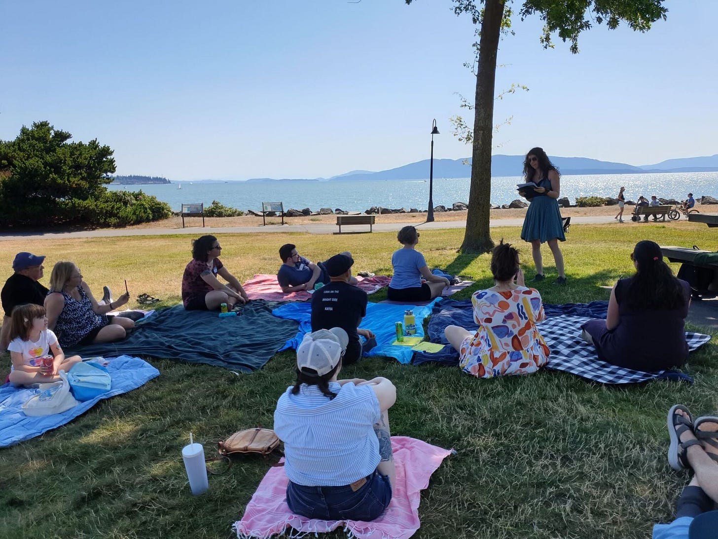 A group of people overlooking the bay for an outdoor summer reading