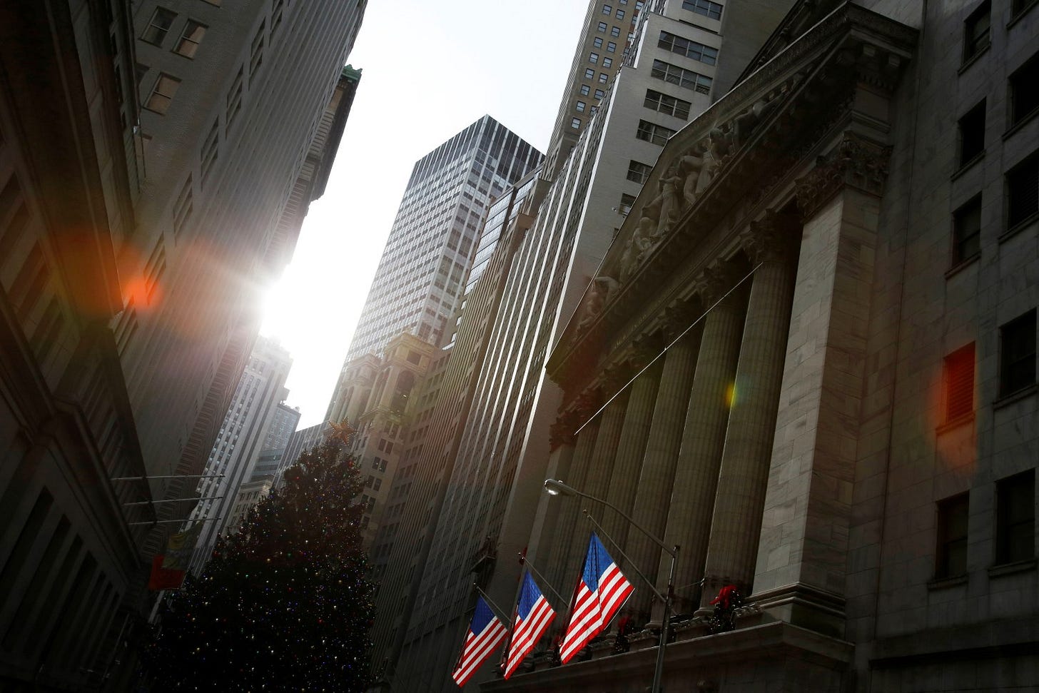 U.S. flags hang at the New York Stock Exchange in Manhattan, New York City, U.S., December 21, 2016. REUTERS/Andrew Kelly - RC166FFF9250 U.S. flags hang at the New York Stock Exchange in Manhattan, New York City, U.S., December 21, 2016. REUTERS/Andrew Kelly - RC166FFF9250