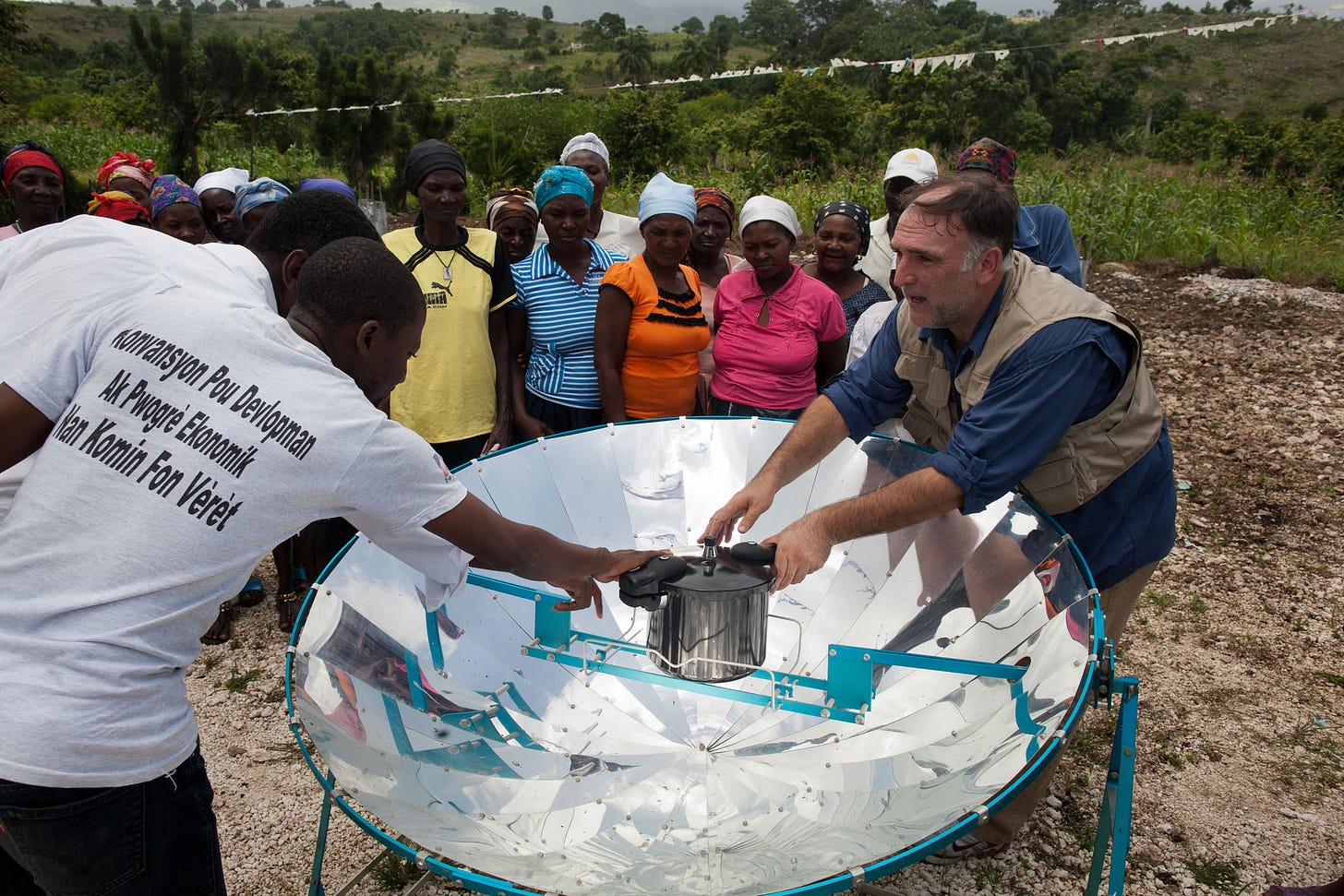 José Andrés using a pressure cooker and solar stove at a school in Haiti in 2012.