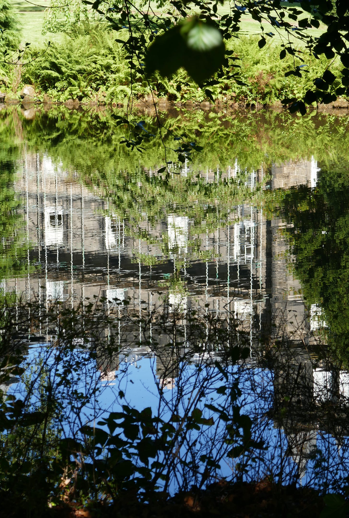 old ilkley college reflected in water