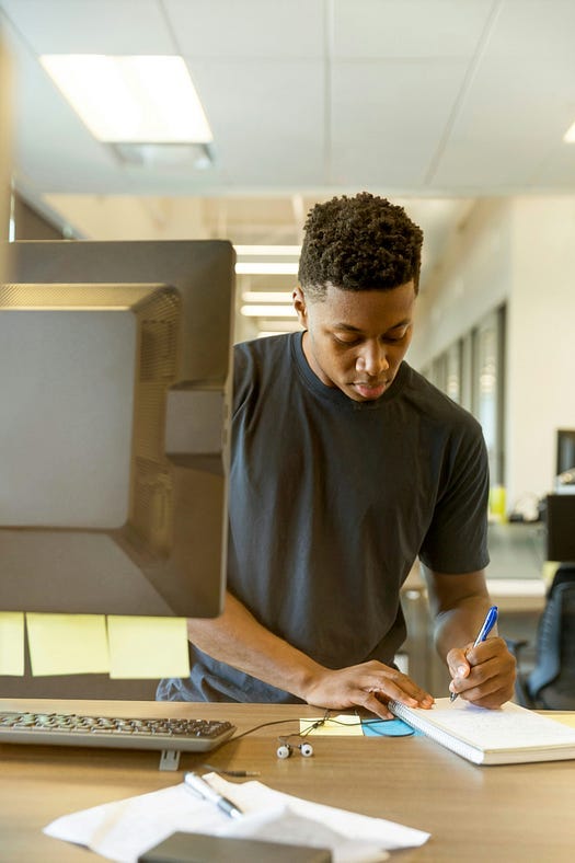 Young person writing in a diary.