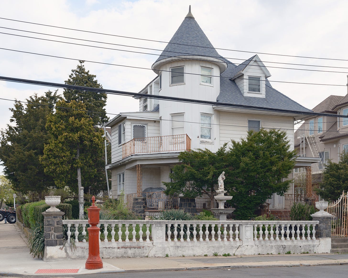 Queen-Anne-Style-house-with-Concial-Roof and-Statue-in-front-Bath-Beach