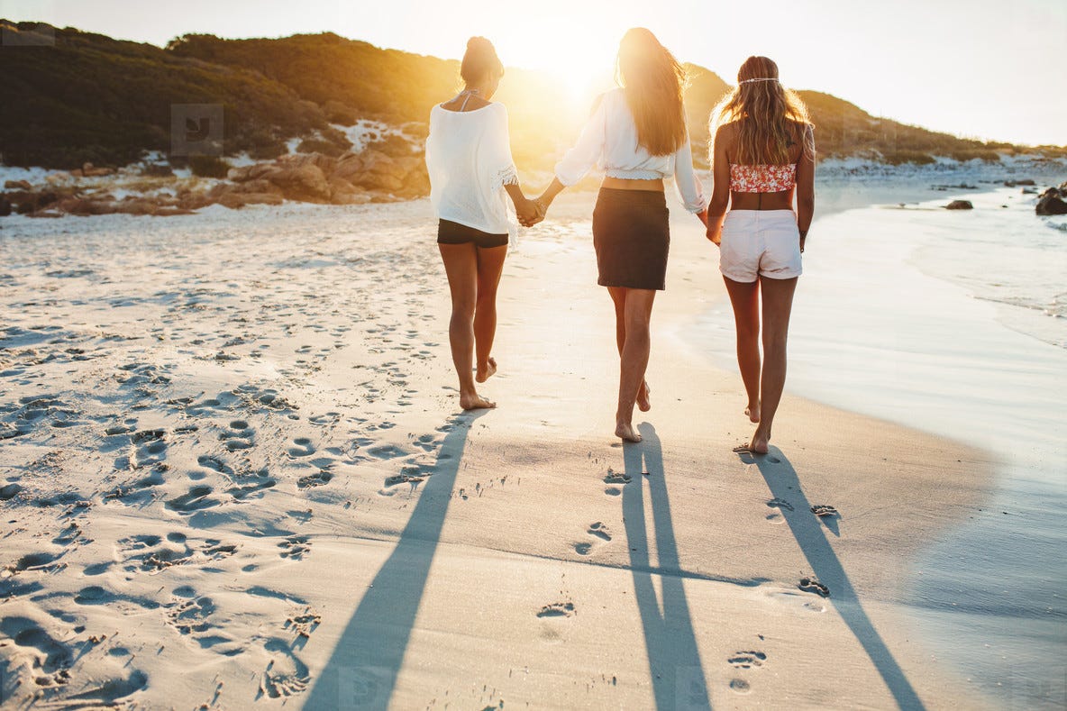 Three friends walking on the beach stock photo (122349) - YouWorkForThem