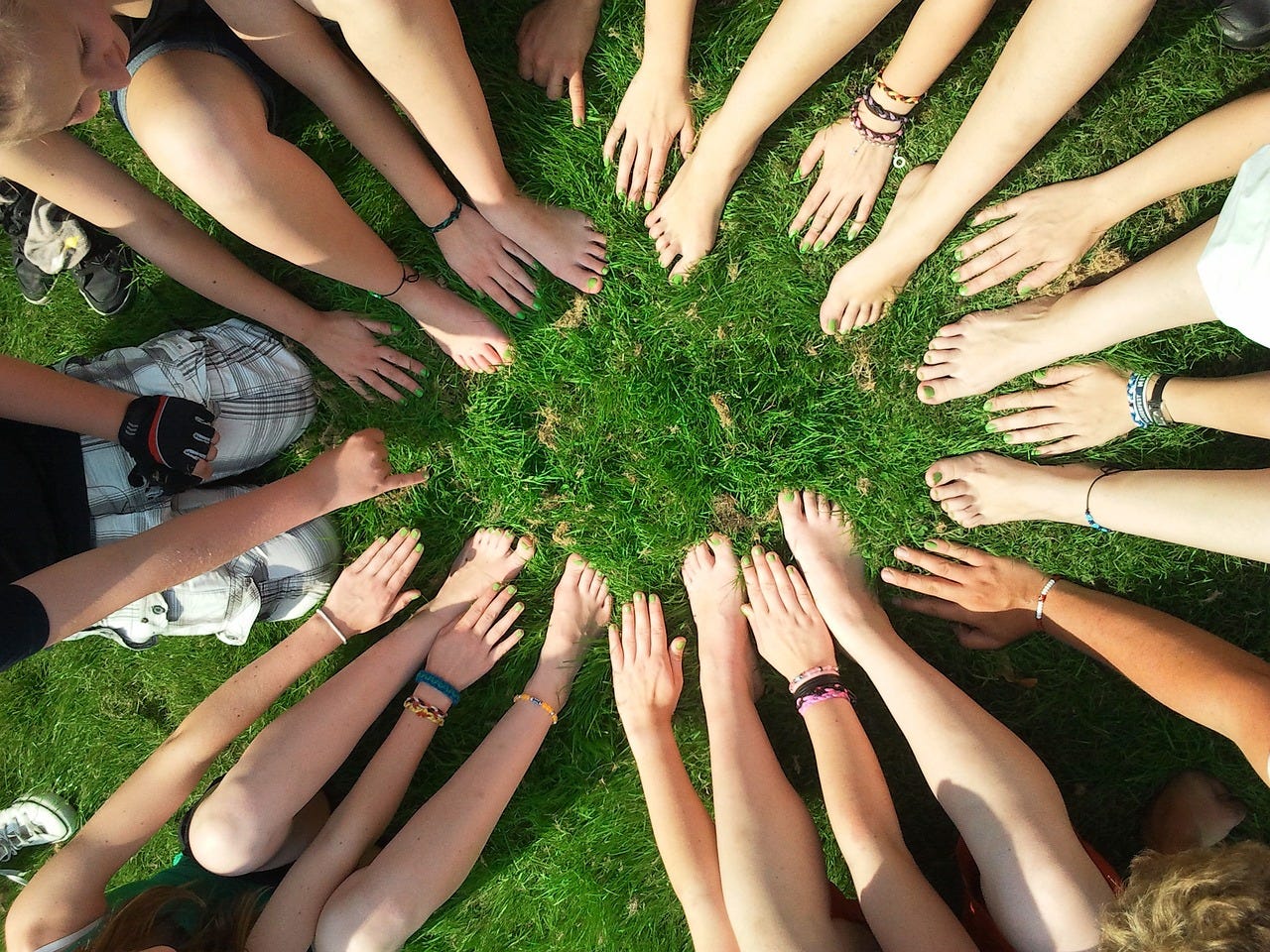 a group of teenage hands in a circle