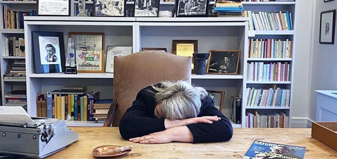 Kathryn Mockler with her head on the desk of the Mordecai Richler room at Concordia University 