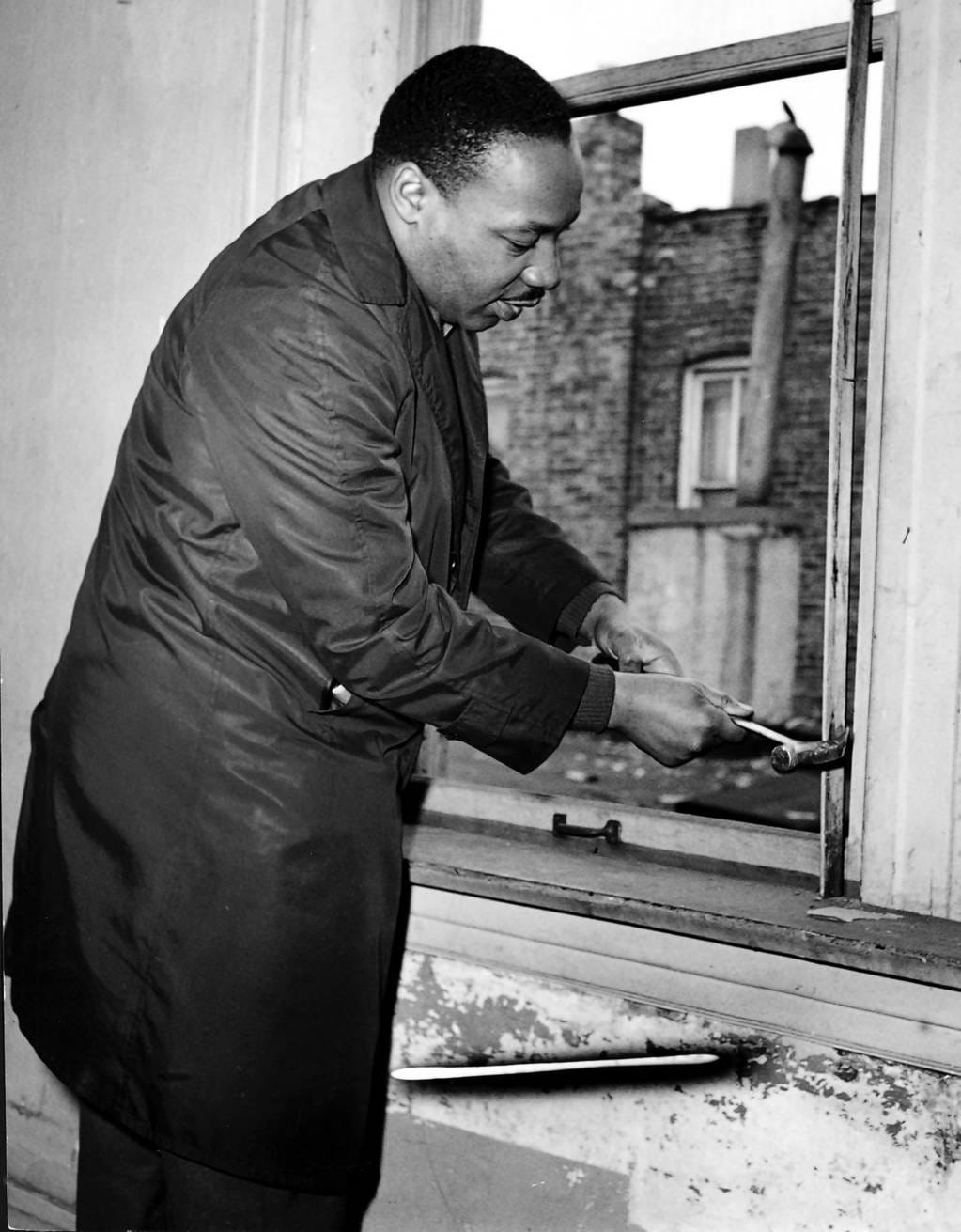 Martin Luther King Jr. helps remove a window frame while renovating an apartment at 1321 S. Loman Ave. in Chicago in 1966. King moved into a West Side apartment at 1550 S. Hamlin Ave. to highlight housing segregation issues in Chicago.