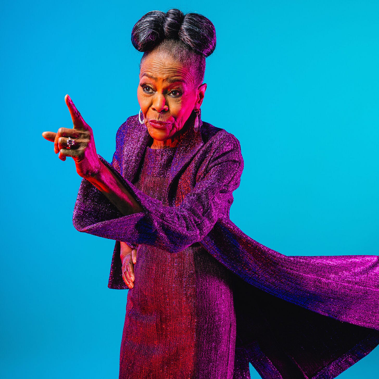 This photo, taken by Mamadi Doumbouya for The New York Times Magazine, shows Cicely Tyson wearing a flowing mauve dress and pointing toward the image's left-hand side. Tyson purses her lips as if about to speak to someone standing off-camera. This photo, taken by Mamadi Doumbouya for The New York Times Magazine, shows Cicely Tyson wearing a flowing mauve dress and pointing toward the image's left-hand side. Tyson purses her lips as if about to speak to someone standing off-camera.