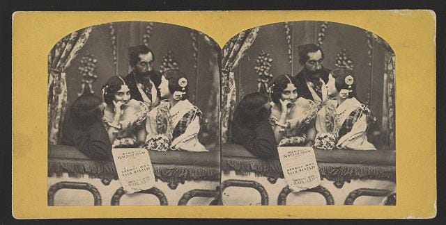 Photograph shows two couples at the theater. A Playbill with text "Laura Keene, New Theater, Our American Cousin, Seventh Week, New Comedy" hangs over the side of their box seating. Image may depict actress Laura Keene whose show opened in New York City, October 1858. 