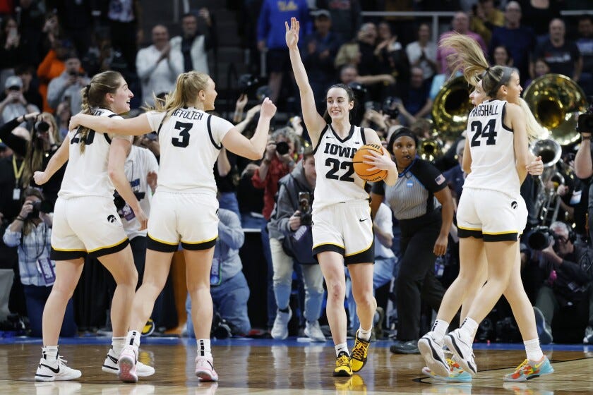 Caitlin Clark (22) of the Iowa Hawkeyes and her teammates celebrate after beating the LSU Tigers 94-45 in the Elite Eight in Albany, New York.