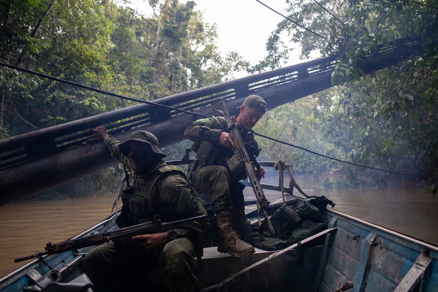 Armed with assault rifles, special forces troops from Brazil’s environmental protection agency, Ibama, inspect a dredger.
