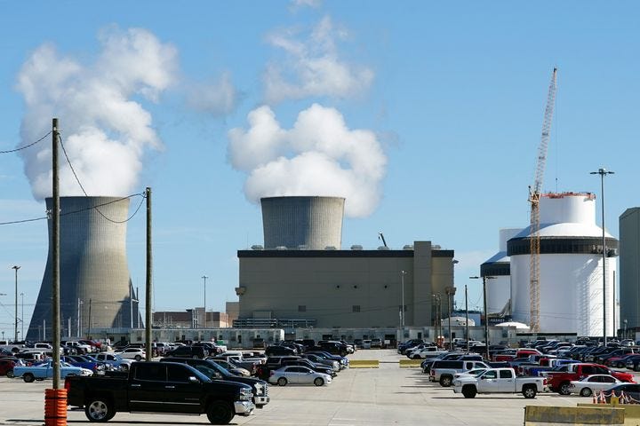 Reactors for Units 3 and 4 sit at Georgia Power's Plant Vogtle nuclear power plant on Jan. 20 in Waynesboro, Georgia, as cooling towers of the older Units 1 and 2 billowing steam. Unit 3, completed in July, is the first new reactor built from scratch in the U.S. in a generation.
