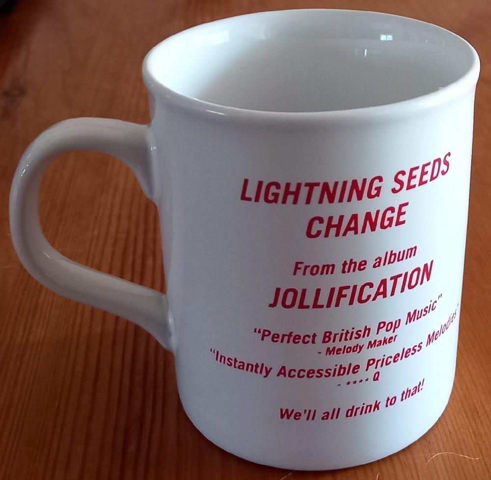 B-side of the Lightning Seeds mug, with the words “Lightning Seeds. Change. From the album Jollification. We’ll all drink to that!”