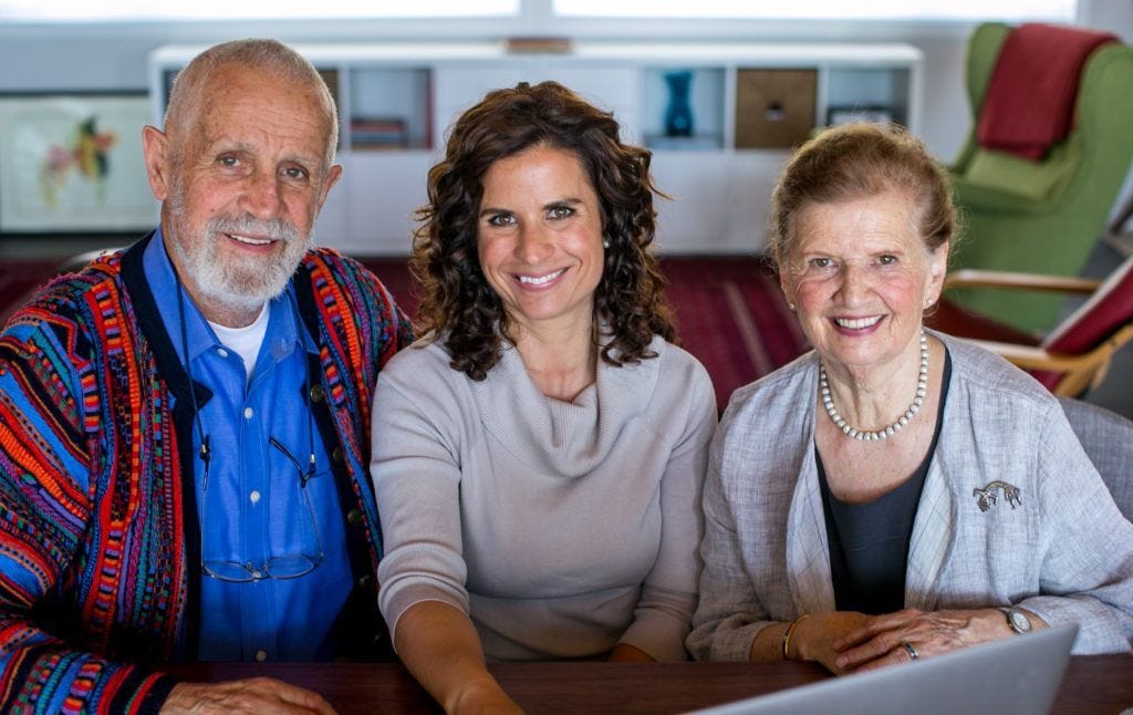 A family of implementation genius-makers smiling at the camera