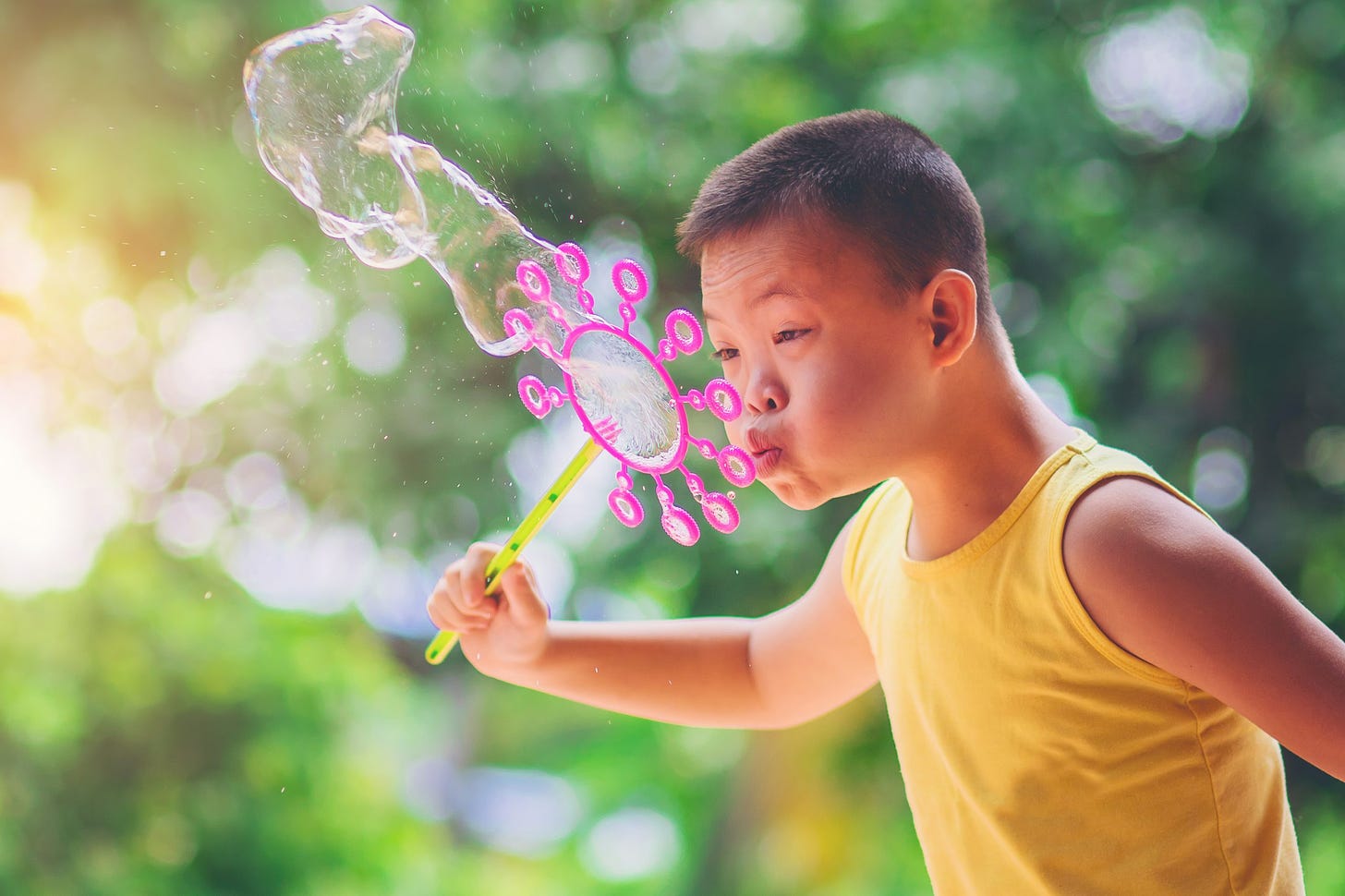 Asian,Boy,Blowing,Soap,Bubbles,On,Nature,Background.,Outdoors,At