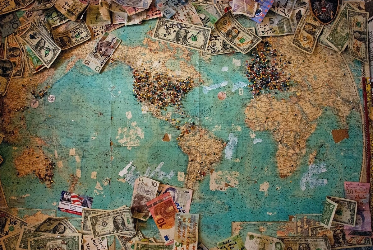 The world and currency placed on the large map.