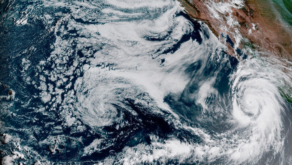 This Friday, Aug. 18, 2023 satellite image provided by the National Oceanic and Atmospheric Administration shows Hurricane Hilary, right, off Mexico’s Pacific coast. It grew rapidly to Category 4 strength and could reach Southern California as the first tropical storm there in 84 years.