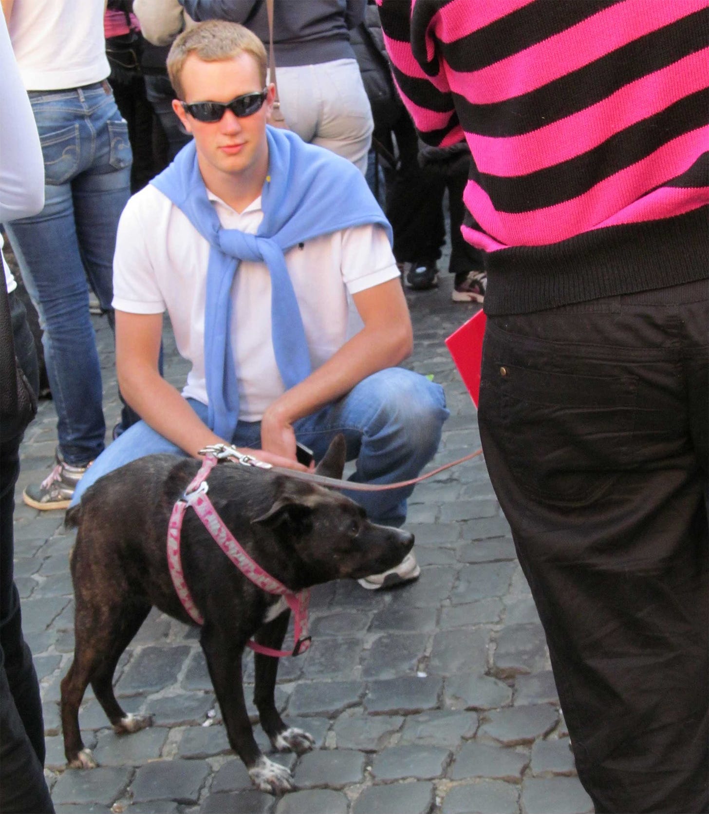 John squatting next to a strange dog in Rome prior to his disability.