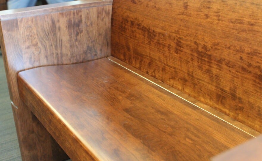 photo of a wooden bench from inside the Durham Courthouse