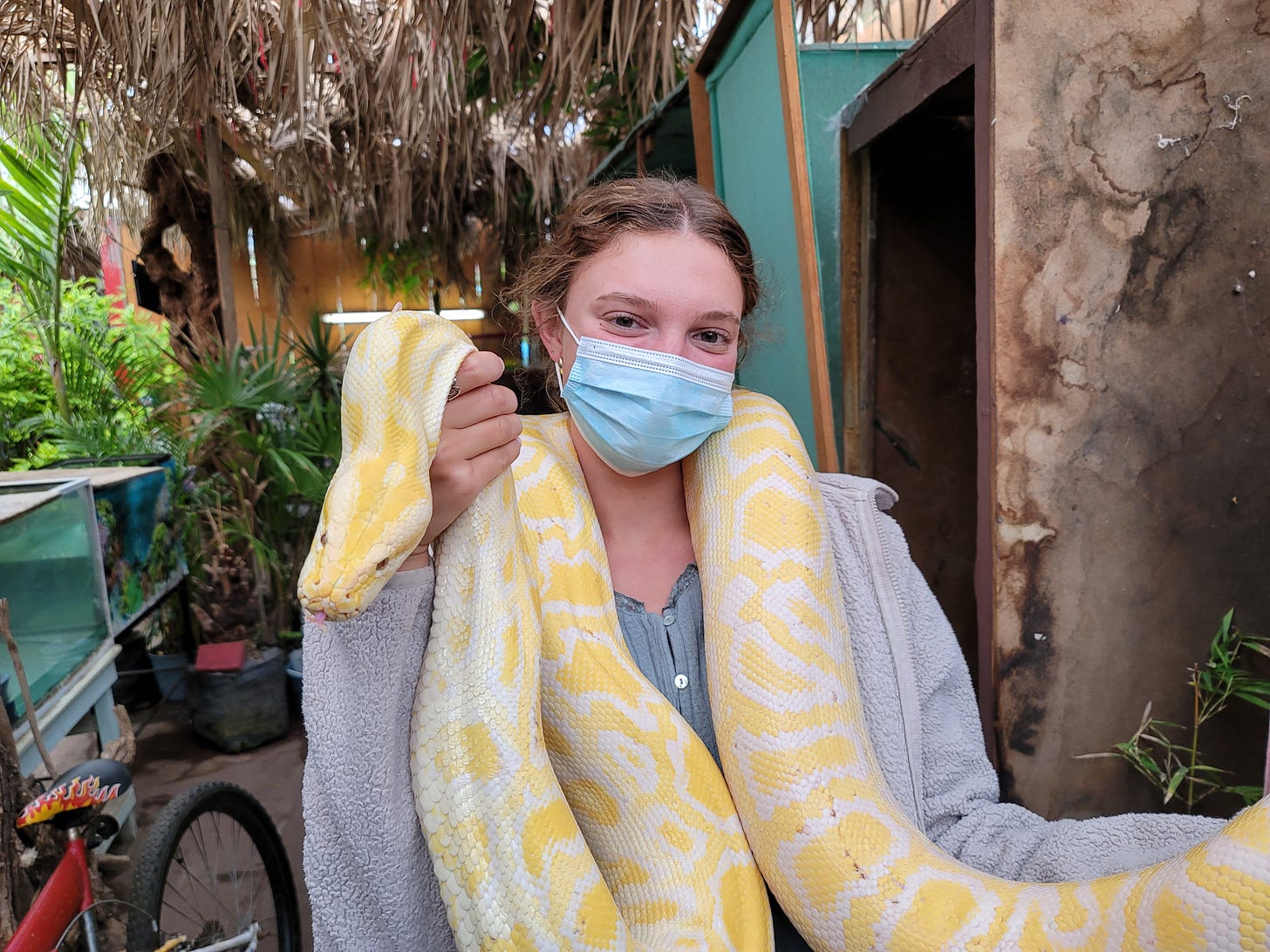 young woman holding a snake