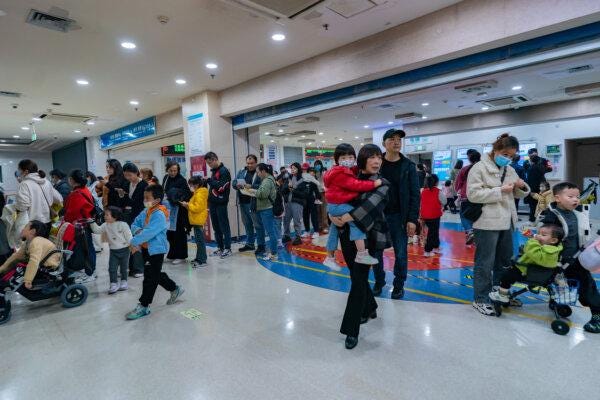 Parents with children suffering from respiratory diseases line up at a children's hospital in Chongqing, China, on Nov. 23, 2023. (CFOTO/Future Publishing via Getty Images)