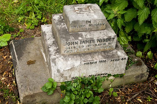 Three stone steps with headstone inscriptions on each step. 