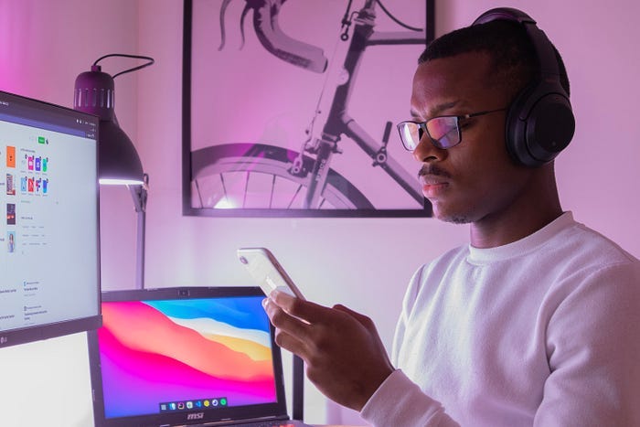 Person working at desk looking at phone