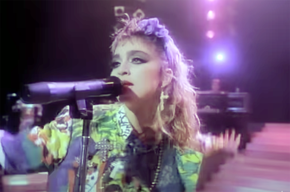 Madonna in the video for Dress You Up singing into a microphone