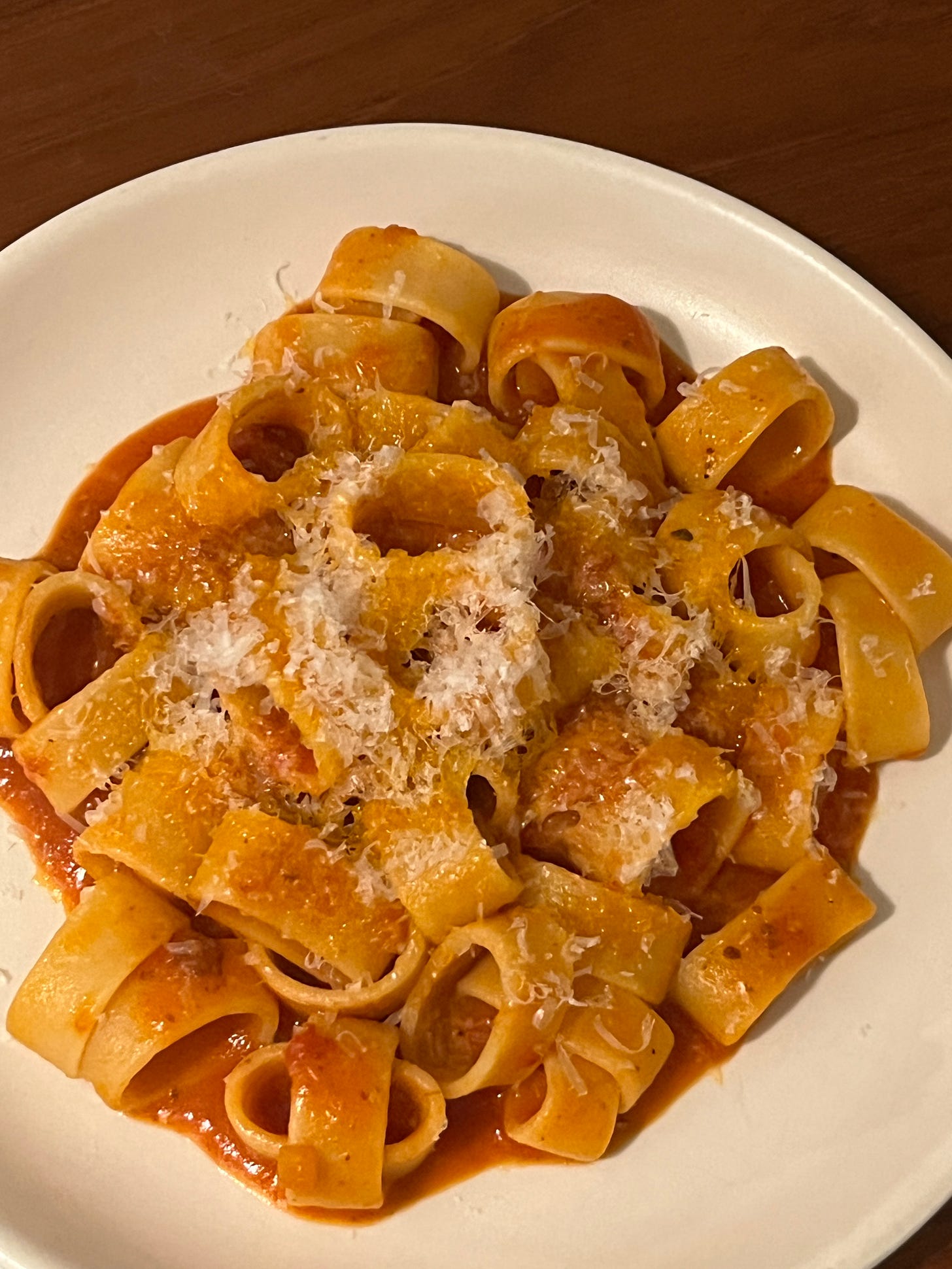A plate of pasta with red sauce.