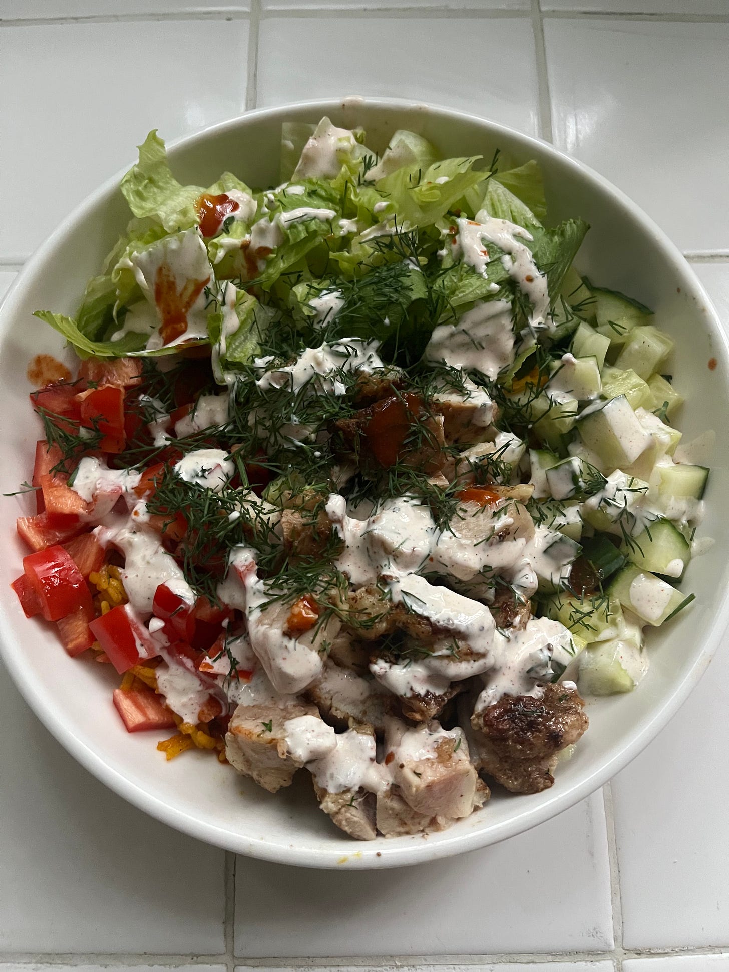The same chicken bowl, now with white sauce, hot sauce and fresh dill