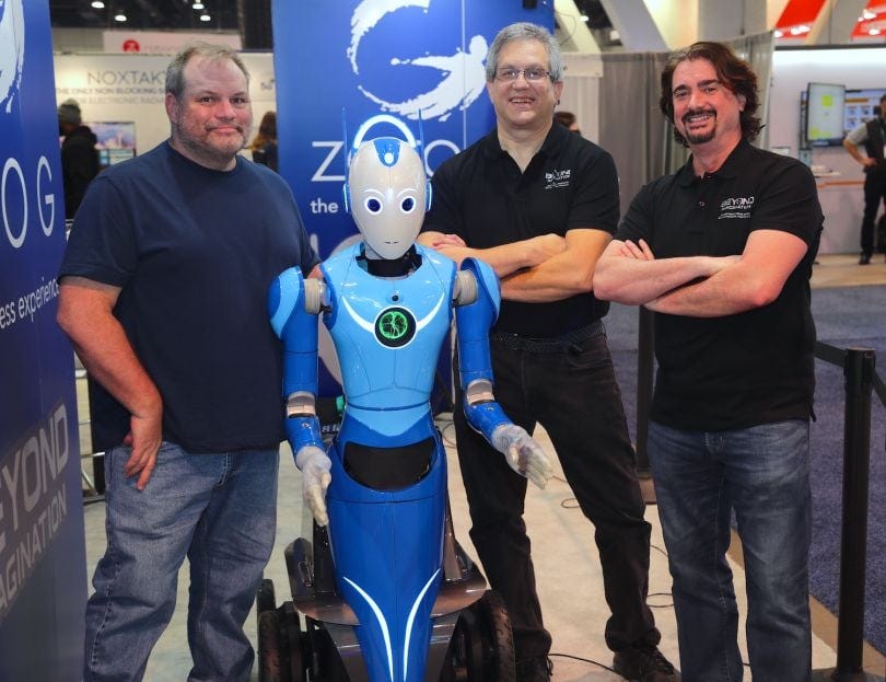 Beomni, a humanoid robot was showcased at the Consumer Electronics Show in January 2021. The robot is pictured with, from left, Chief Digital Officer John Best, Chief Production Officer Bill Fischer and CEO Harry Kloor. | Photo: Beyond Imagination