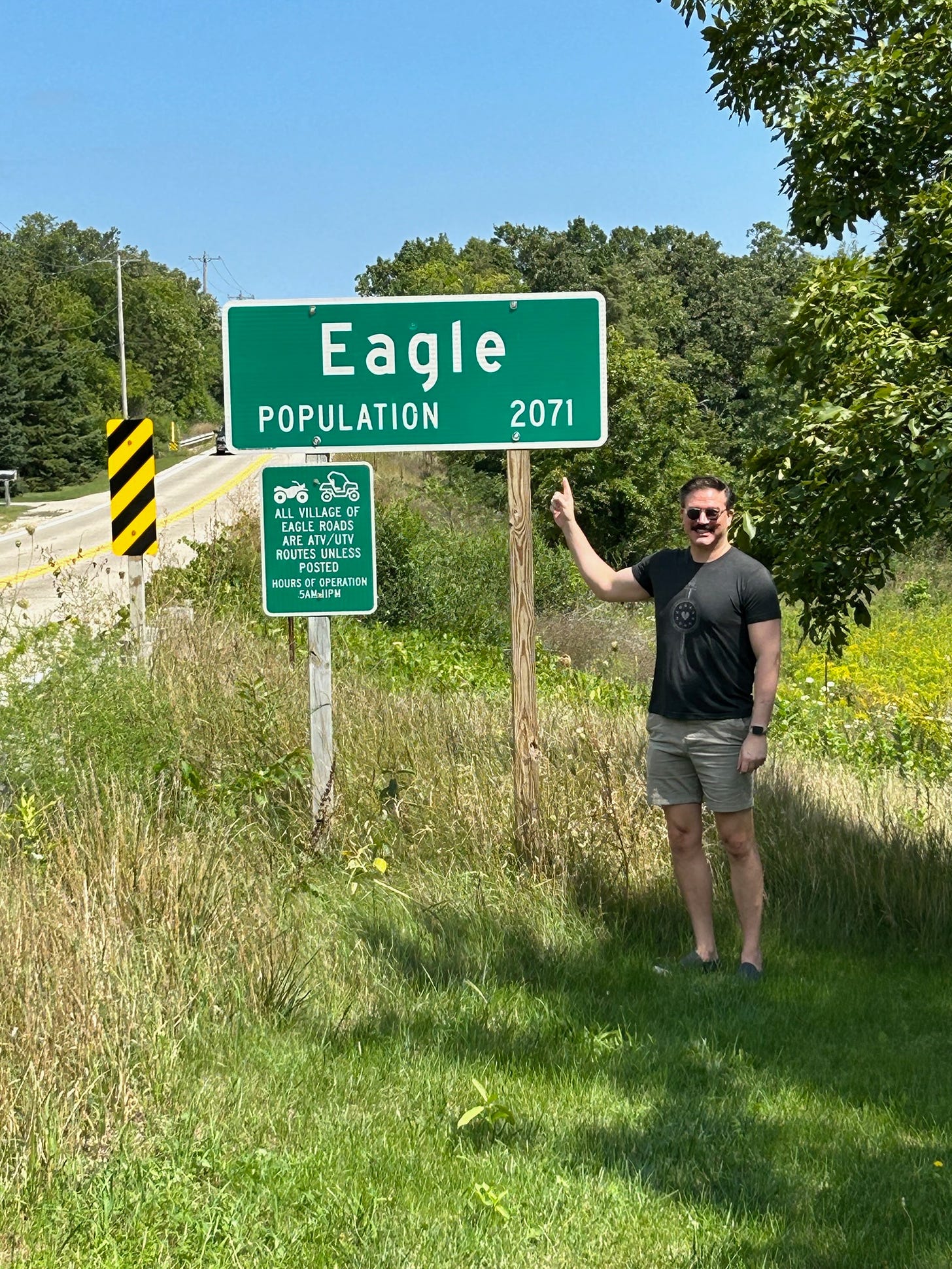 Charlie at Eagle's population sign