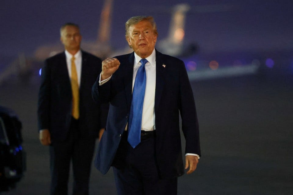 President Trump gesturing upon arrival at Joint Base Andrews.