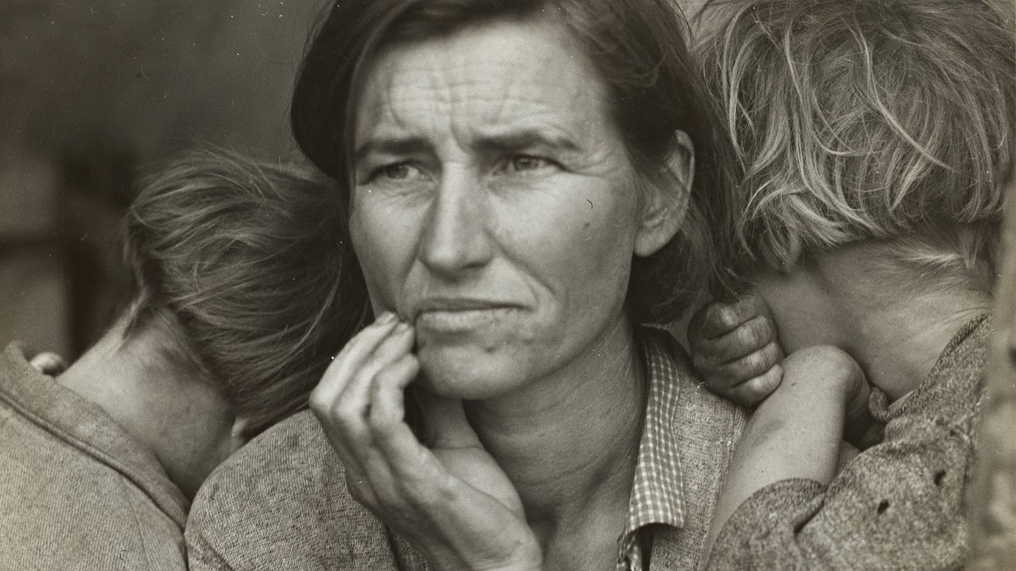 Black and white portrait of a worried-looking woman with two children burying their faces in her shoulders.