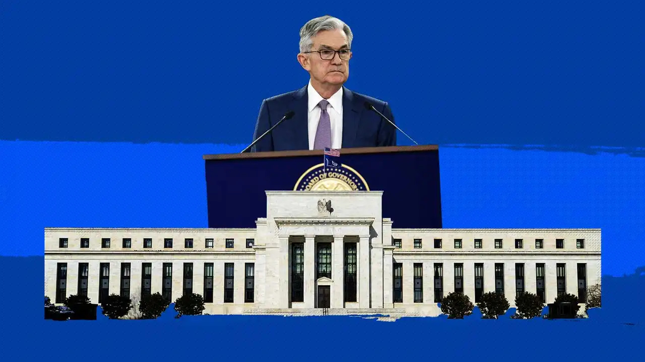 Fed Char Jerome Powell over the Federal Reserve building.