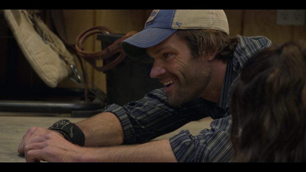 Walker Jared Padalecki as Duke on floor in baseball cap with Adriana