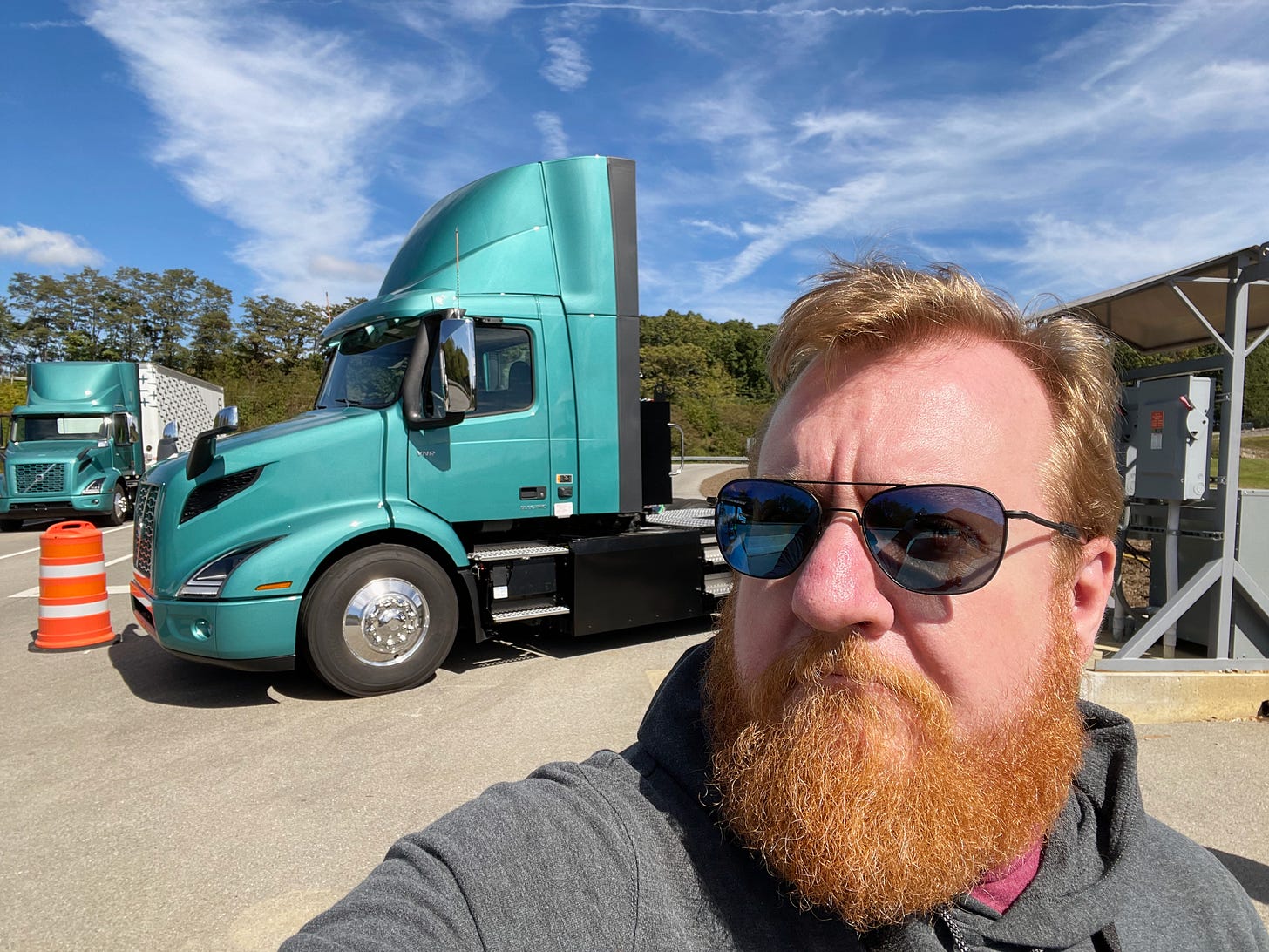 Car journalist Jordan Golson with a Volvo VNR Electric truck in the background.