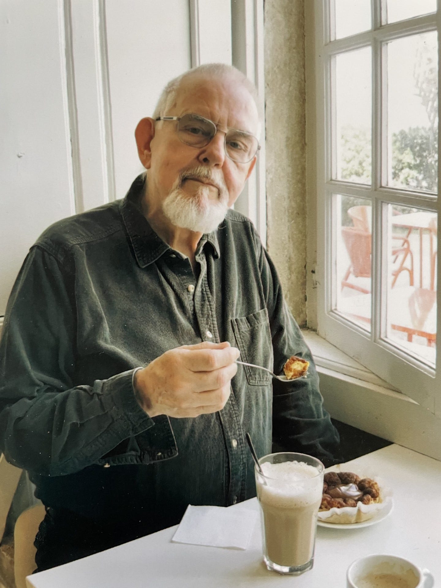 Brian Astbury with a coffee and a cream cake
