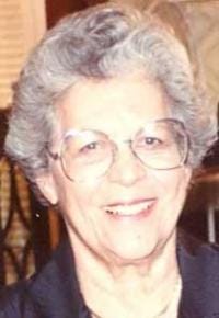 A color photograph of a white woman with glasses and short gray hair. 