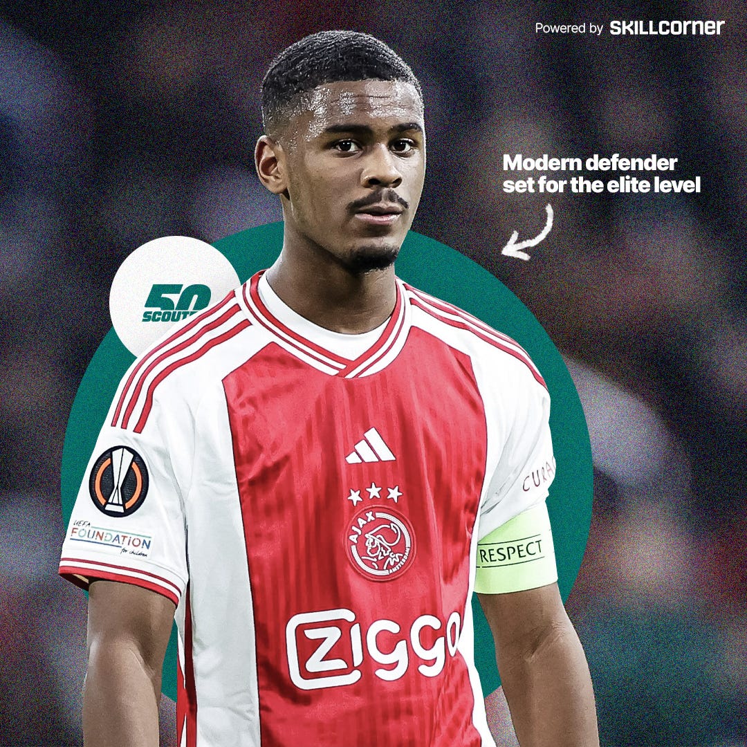 A photo of Jorrel Hato wearing a red-and-white AFC Ajax shirt and a yellow captain's armband. He's looking toward the camera with a pensive look on his face. Behind him are green and white circles, the latter with the SCOUTED50 logo inside it.