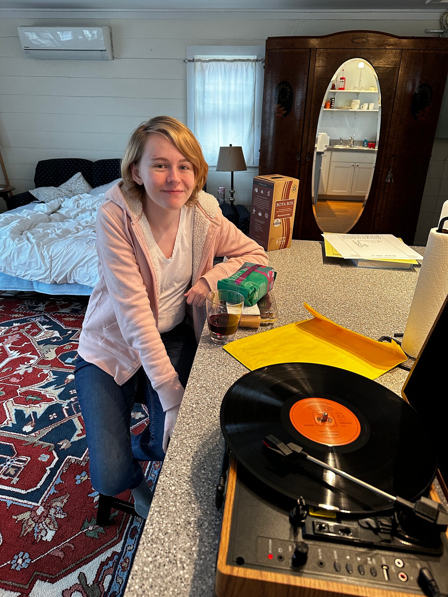 My eldest sitting next to a record player, thus thumbing their nose at the space-time continuum.