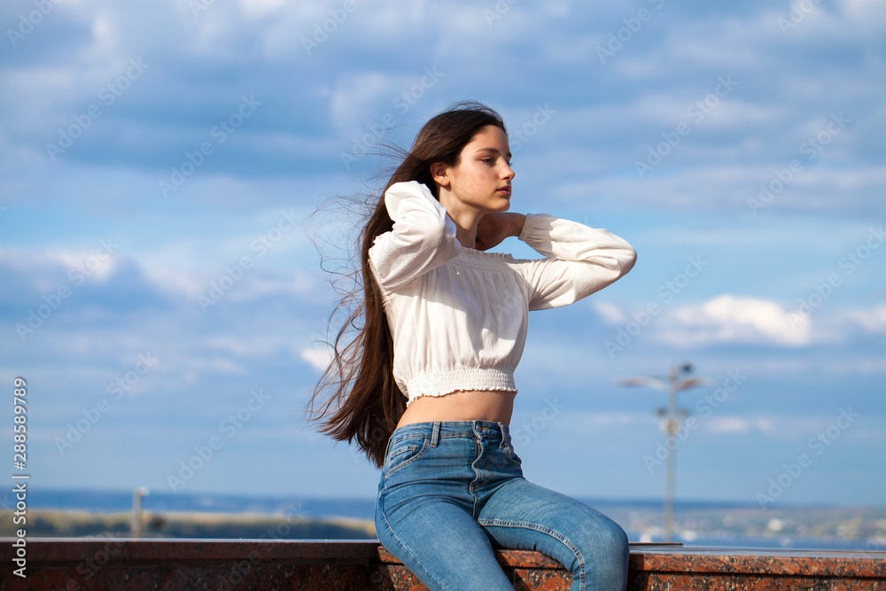 Young beautiful teen girl in blue jeans Stock Photo | Adobe Stock
