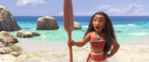 Gif from Moana featuring the main character holding a paddle on the beach